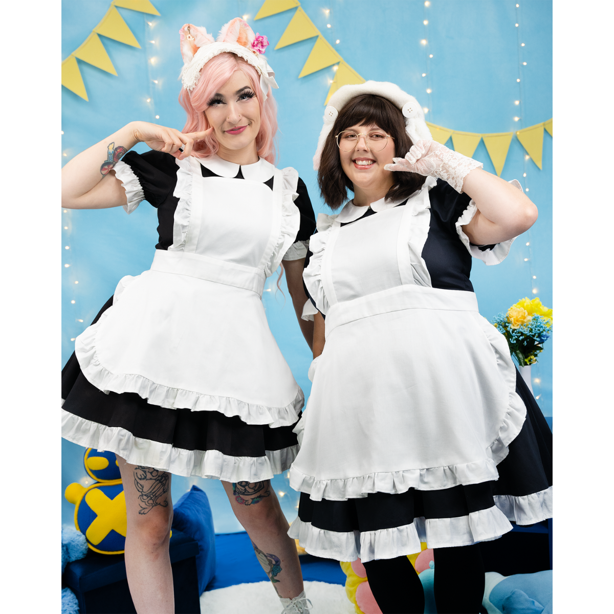 Model, sugarvail_ (size C), and a plus size model (size J) posing together in the Maid Outfit (women's) in a way that highlights features of the dress, like ruffled apron and a-line skirt.