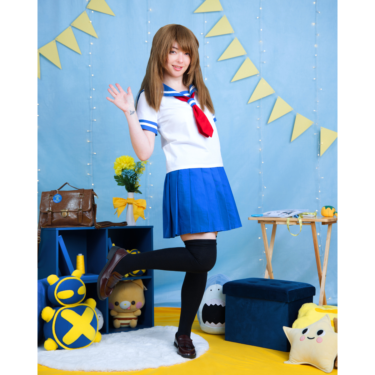 Female model (size C) posing in a white and blue school uniform outfit that contains the Pleated Skirt and Sailor Blouse. The skirt is the shorter legnth, and the blouses sleeves are also short.