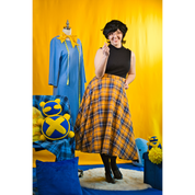 Size C model posing in the Sleeveless Turtleneck. It is paired with a long skirt.