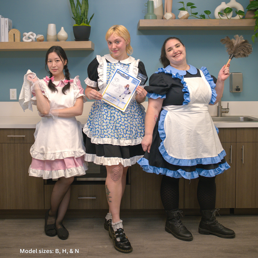 A photo of 3 people wearing maid outfits. The first one is wearing a pink dress with white ruffles and a fully white apron (size B), the second is wearing a black dress with white ruffles and the apron is blue floral print and white ruffles (size H), the third is a black dress with pastel blue ruffles and the apron is white with blue ruffles (size N).
