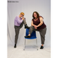 A nonbinary, size C model and a female, size J model posing while wearing the completed Pants (f). They are angled toward each other while propping one leg each on a chair. The pants of the size J model are cuffed to show styling variety.
