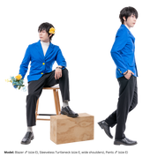 Male model, matthew_aizel, in different poses while wearing the Pants (men's) and blazer. In one variant, he's sitting on a stool and propping one leg on a box, demonstrating the pattern's relaxed fit. In the other, he is profiled to the camera with one hand in his pocket.