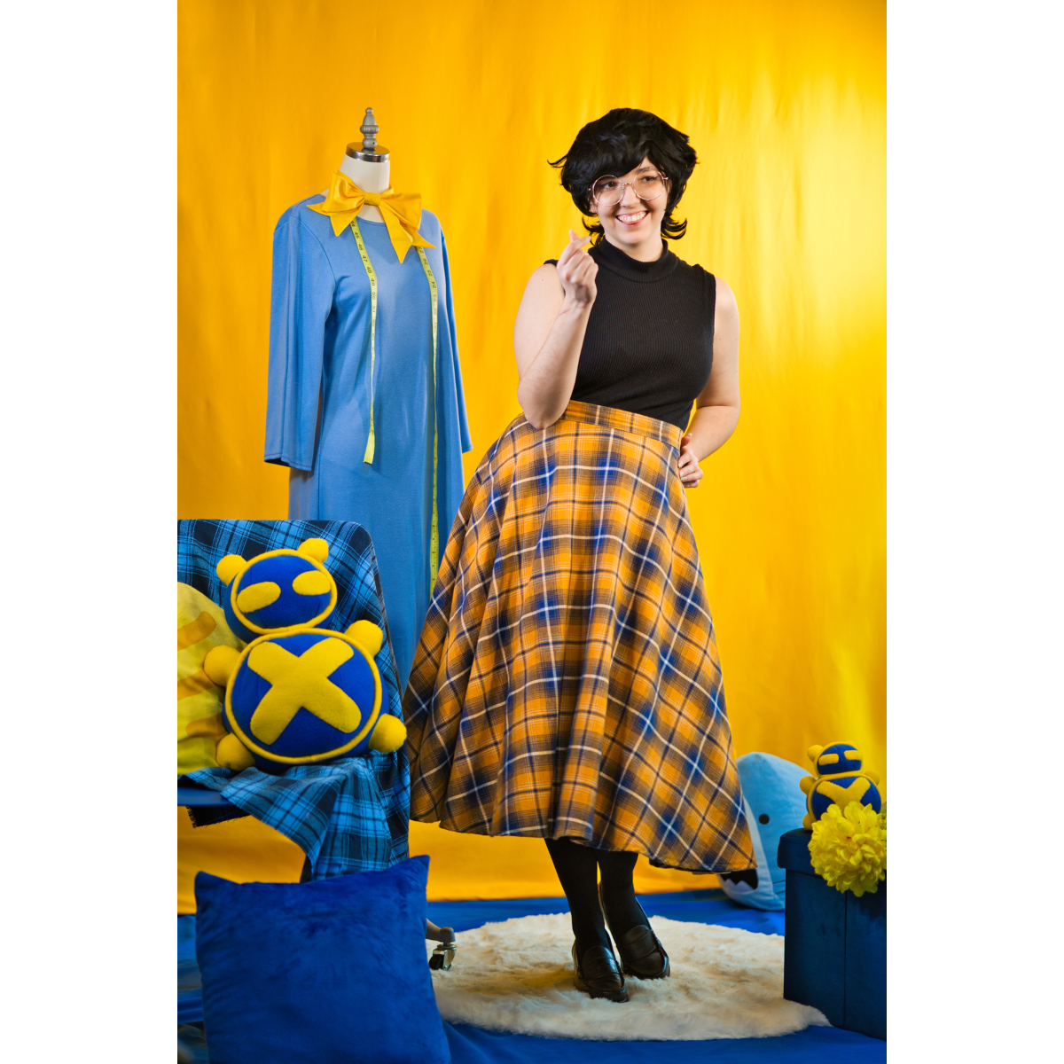 Size C model posing in the Sleeveless Turtleneck. It is paired with a long skirt.