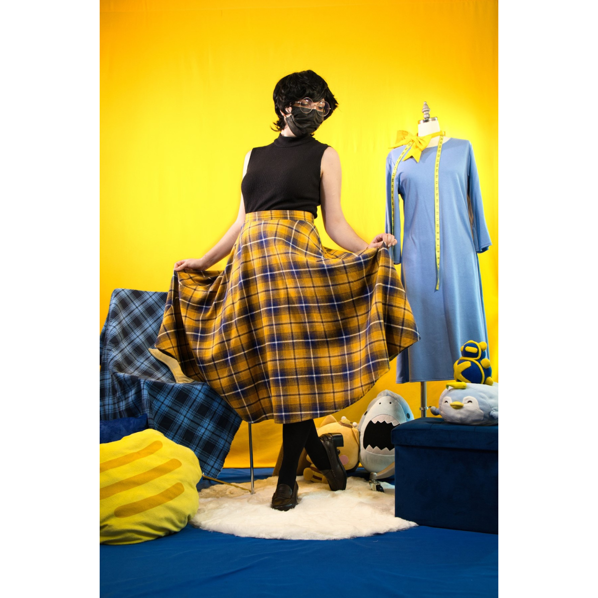 Model (size C) posing in the Circle Skirt and turtleneck. They're holding the skirt up to demonstrate the fullness and drape.