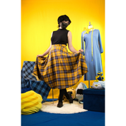 Model (size C) posing in the Circle Skirt and turtleneck. They're holding the skirt up to demonstrate the fullness and drape.