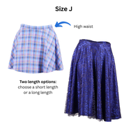 Size J Circle Skirts in both the short and long versions with text and an arrow pointing out the high waist. Text at the bottom states the pattern has two length options. 
