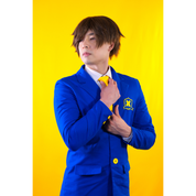 Male model (size E) posing in the Blazer. He is adjusting a necktie, displaying the buttons on the sleeve cuffs, pockets, and front closure buttons.