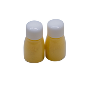 Image of the two bottles of yellow Clover Chaco Refill outside of its packaging. The chalk powder is visible inside the bottle.