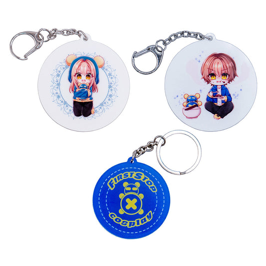 The front faces of three different keychains: (1) Pan keychain; (2) Dah keychain; and (3) the "First Stop Cosplay" logo circle stitch keychain.