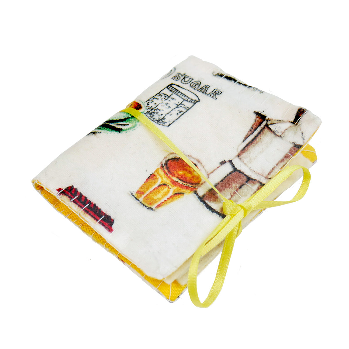 A single completed Needle Book with a cafe latte patterned fabric on the outside, white felt pages on the inside, and a thin yellow ribbon tying it closed around with a bow.
