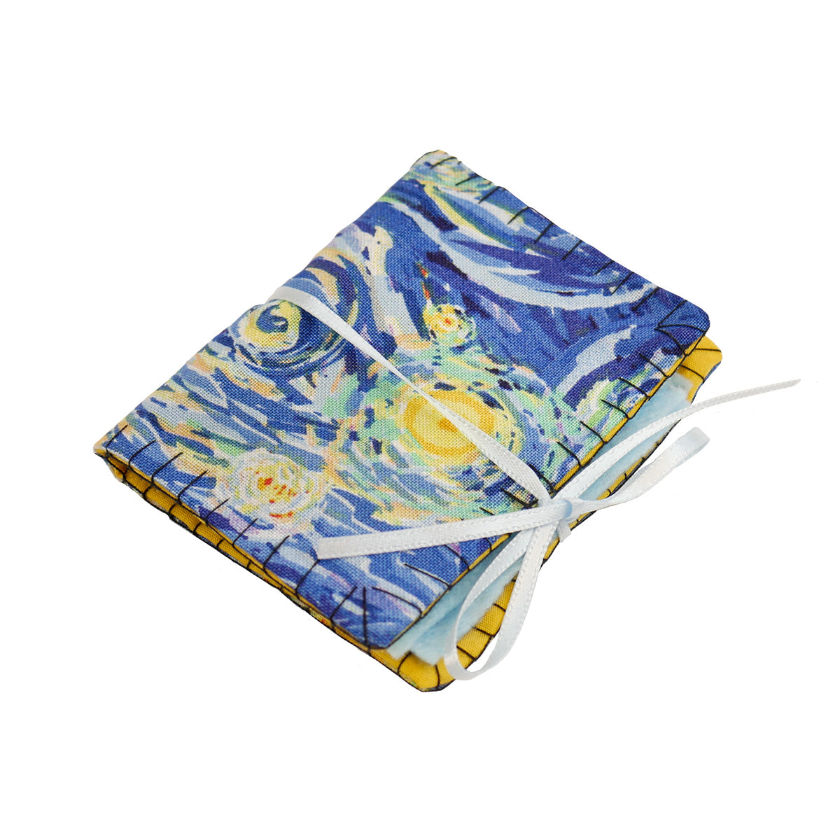 A single completed Needle Book with a starry night patterned fabric on the outside, blue felt pages on the inside, and a thin light blue ribbon tying it closed around with a bow.