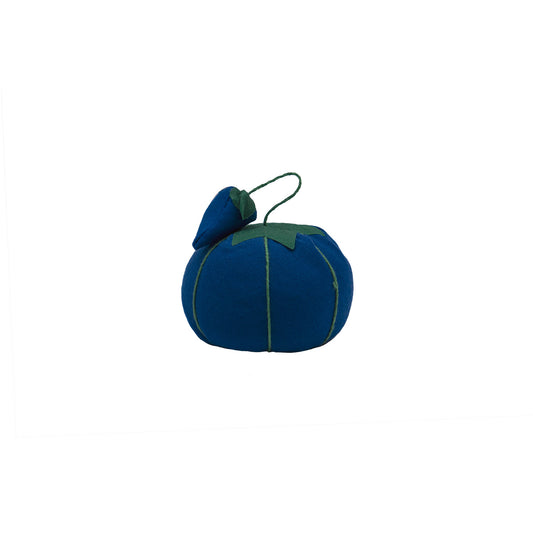 An image of only the blue tomato-shaped pin cushion. The corresponding blue strawberry-shaped emery sits on top.
