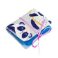 A single completed Needle Book with pandas wearing donuts patterned fabric on the outside, bright blue felt pages on the inside, and a thin pink ribbon tying it closed around with a bow.