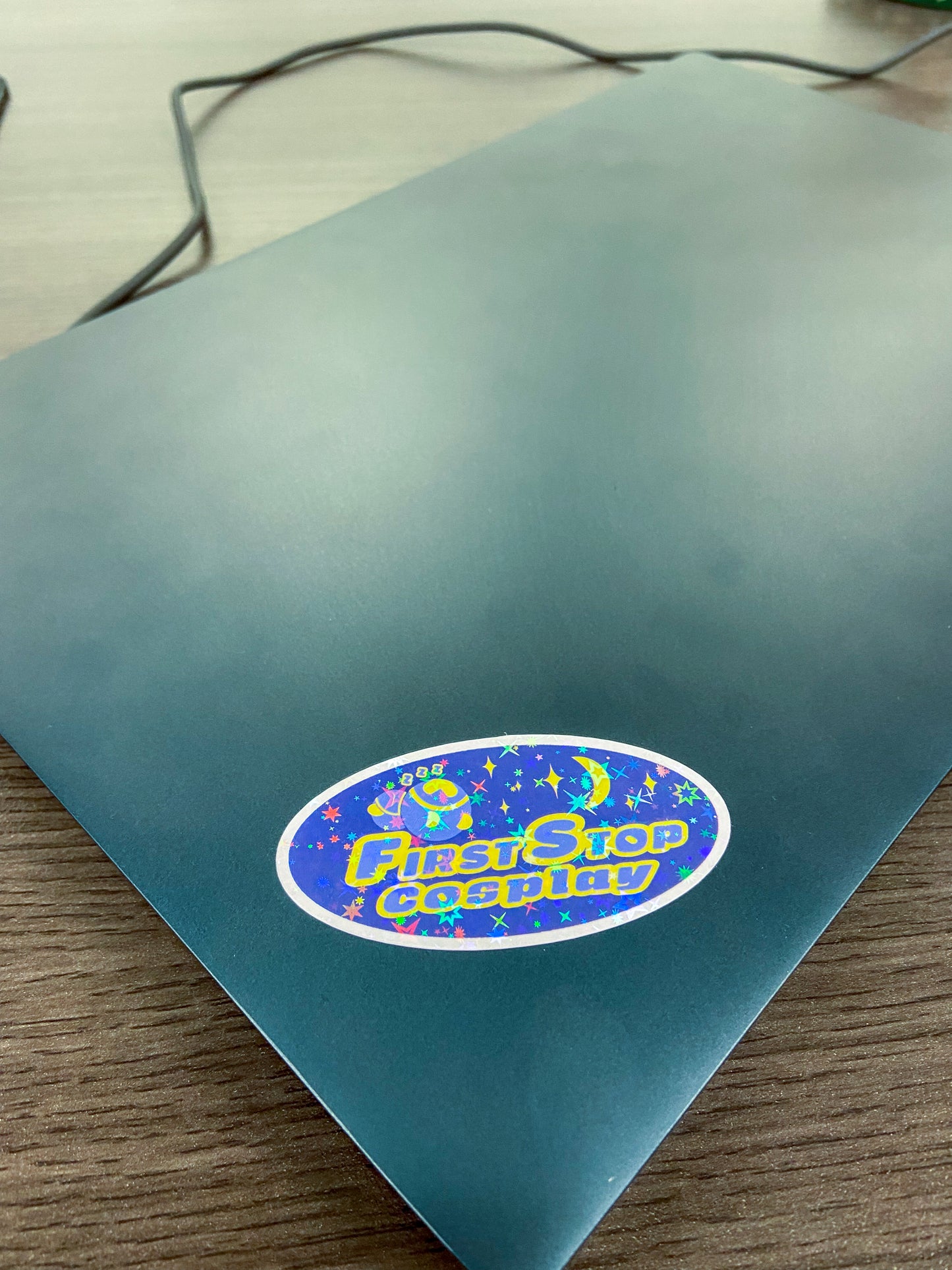 A holographic Sleepy Time Timmy sticker on a closed laptop.